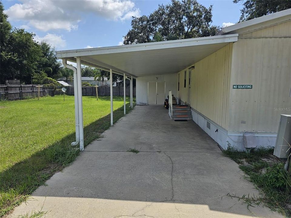 long carport leading to storage shed