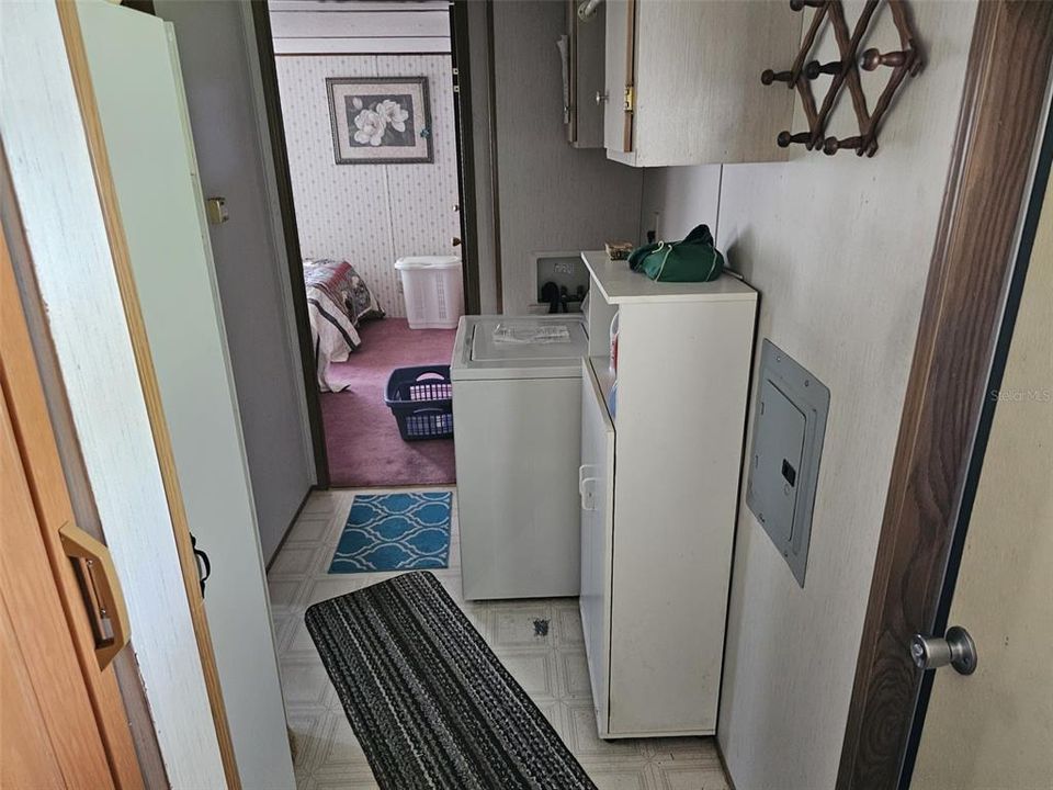 Carport entrance and hall to guest bathroom, second bedroom and laundry area.