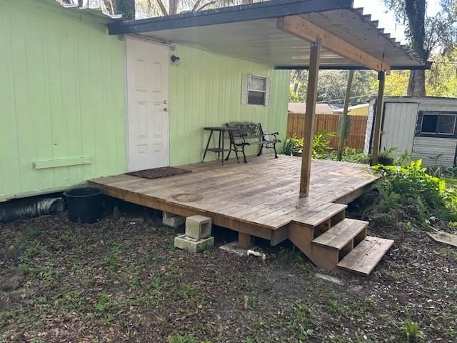 Back porch is new. 1 of 2 storage sheds in the background.