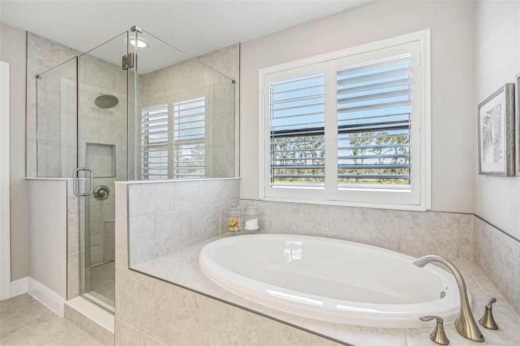 PRIMARY BEDROOM HAS EN-SUITE BATHROOM WITH WALK-IN SHOWER AND OVER-SIZE SOAKING TUB