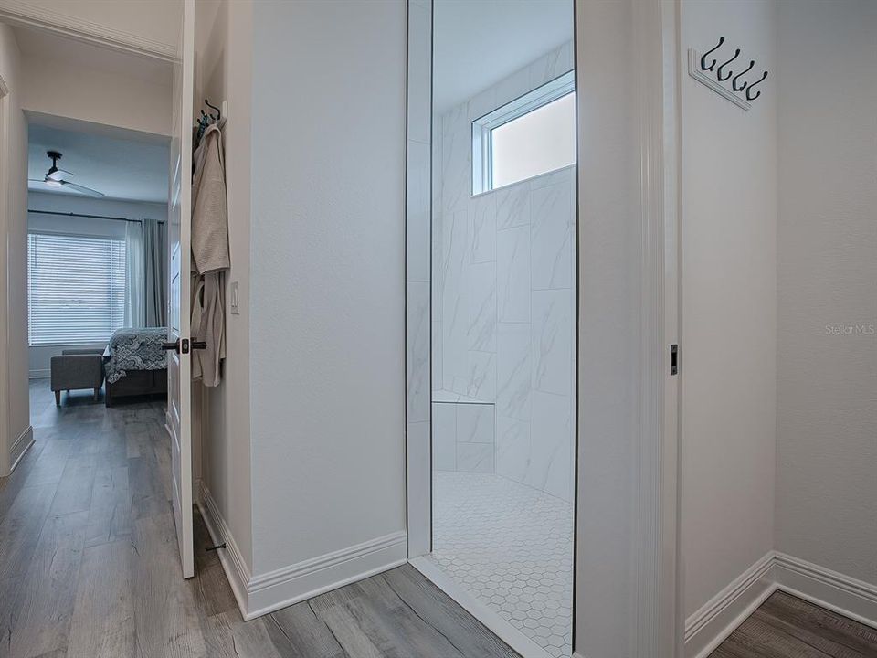 WALK-IN LOVELY TILED ROMAN SHOWER WITH HIGH WINDOW FOR NATURAL LIGHTING.