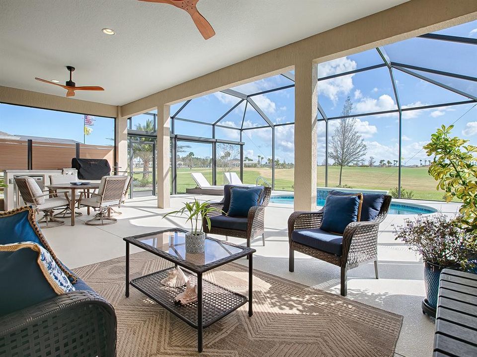 FABULOUS OUTDOOR LIVING SPACE WITH SUMMER KITCHEN, SALT WATER HEATED POOL AND GREAT VIEW OF THE GOLF COURSE!