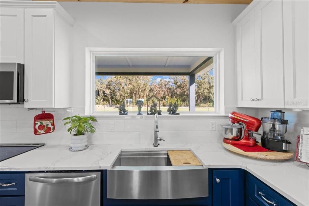 picture window over farm sink in kitchen