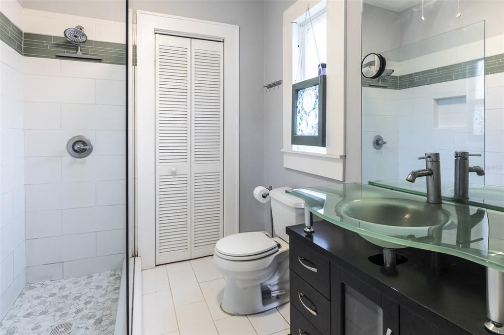 The ensuite bathroom features a walk in shower