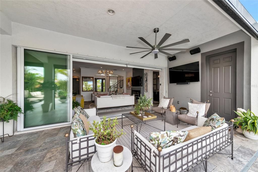 Remote controlled roll down screens, gorgeous Travertine floors and an automatic bug spray system on the lanai and perimeter of the rear yard complete the outdoor living space.