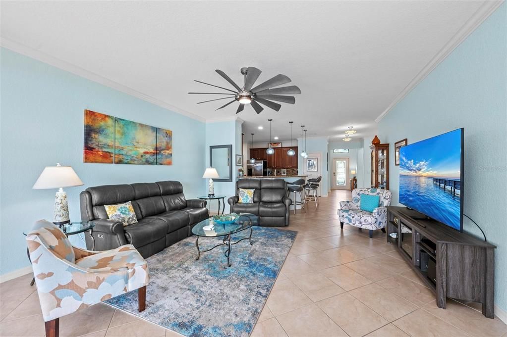 spacious living area ....flows to sliding glass doors to pool and lanai.