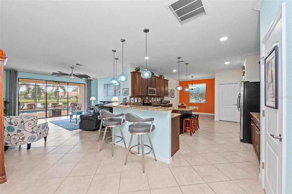 Open plan ....view from dining area to kitchen and great room.  bar space at island and at kitchen counter.