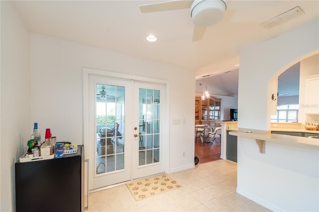 French door entry to screen-enclosed back porch.