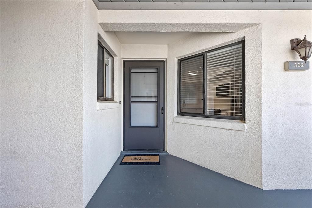 Front Door with screen storm door.