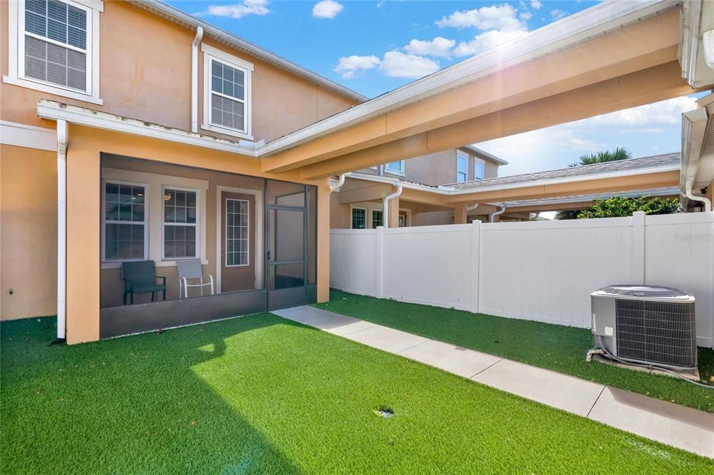 Fully fenced backyard with artificial turf