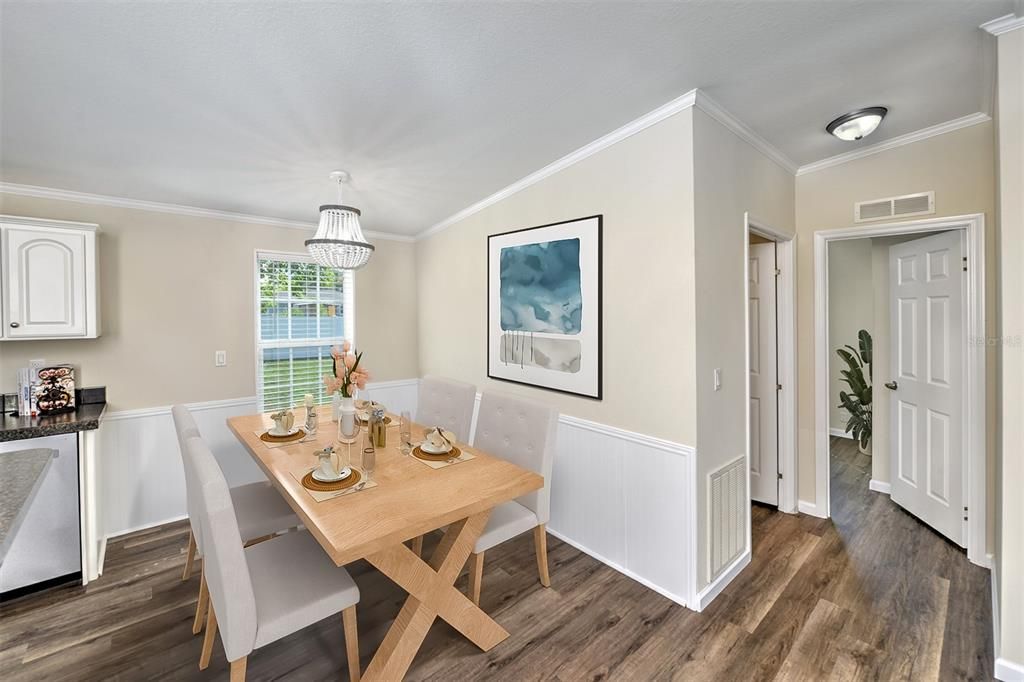 Dining area with wainscoting design on lower part of wall