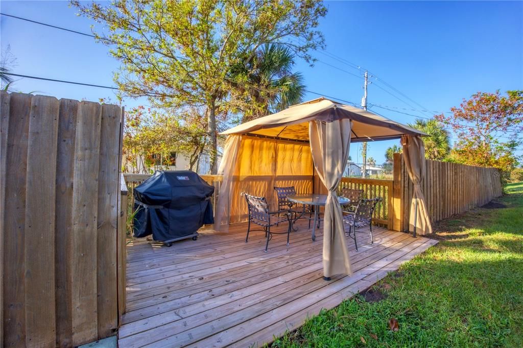 Large deck expands the back yard providing more space for entertaining or dining under the stars.