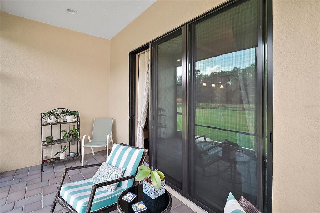 The three-door slider opens to the east onto the screened patio, which is plumbed for an outdoor kitchen. This is the ideal spot for coffee and watching the sunrise.