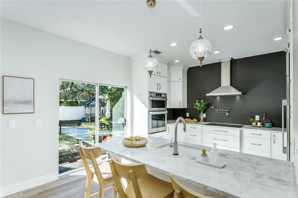 Custom Kitchen with sliding doors to the fenced backyard