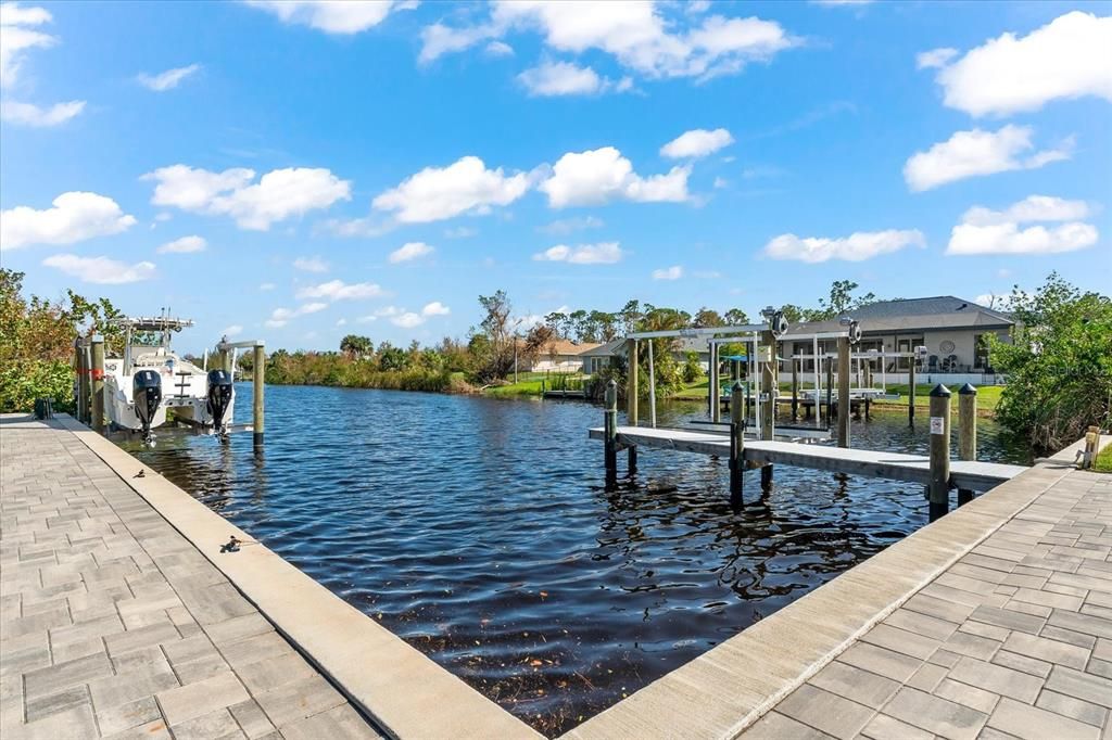 Dock featuring a robust sea wall with lift, making waterfront living effortless and enjoyable.