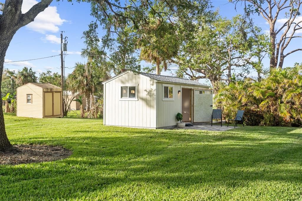 The she-shed or man cave is tucked away in a lush corner of the yard