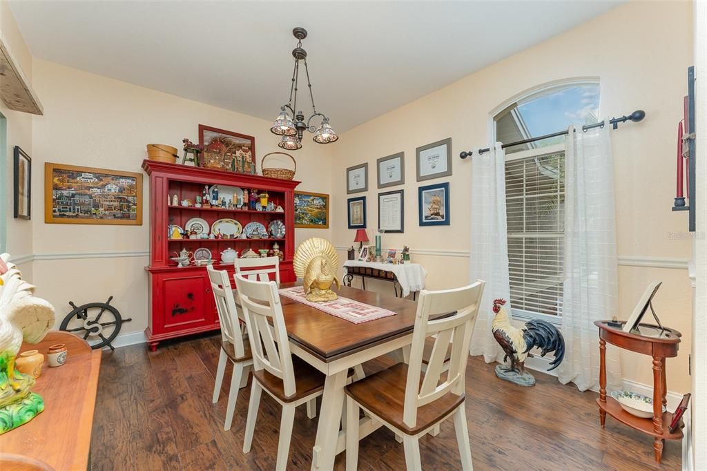 A view of the large formal dining area from the front door entry