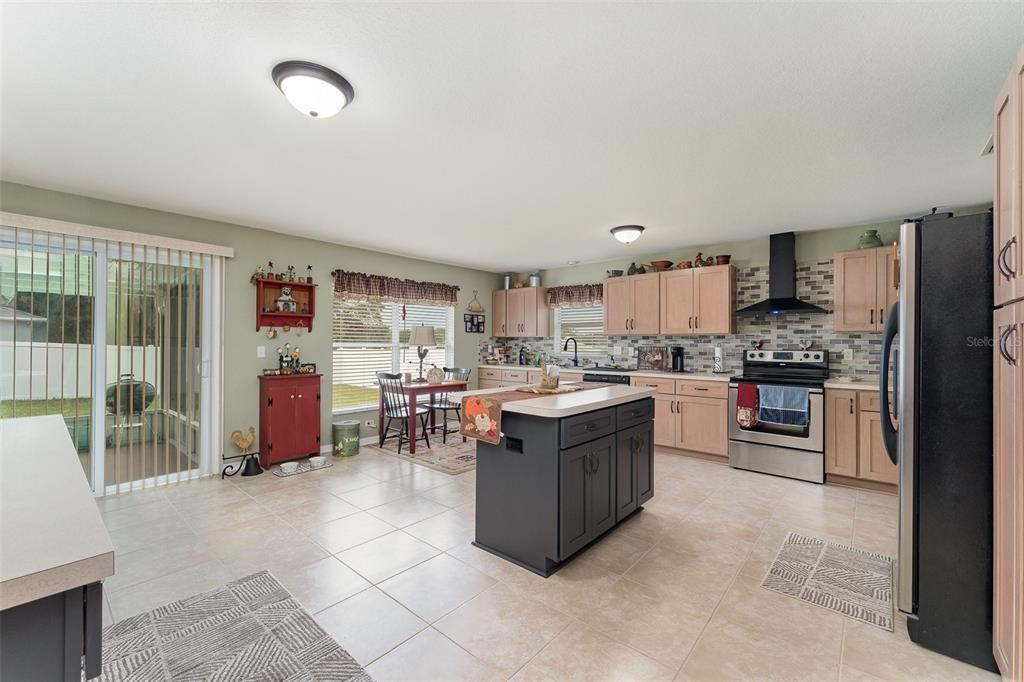 The perfect very large remodeled kitchen with more than enough space to handle large get togethers with an added eating space by the large window and sliding glass doors to the covered screened rear porch