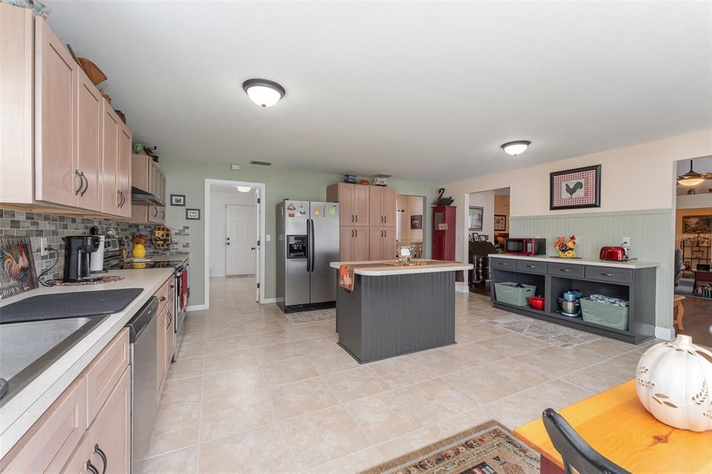 Looking from the sink area to the expansive remodeled kitchen to the left is the very large pantry