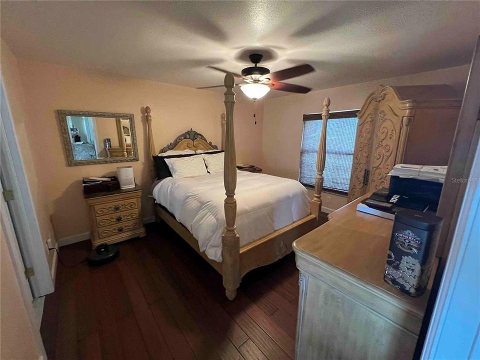 Primary Bedroom with a textured ceiling, ceiling fan, and dark hardwood / wood-style floors