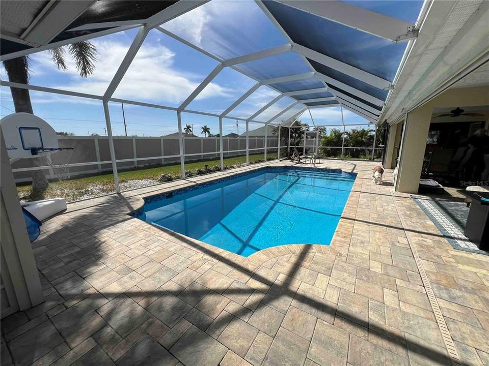 View of swimming pool with screened-in enclosure and lanai area