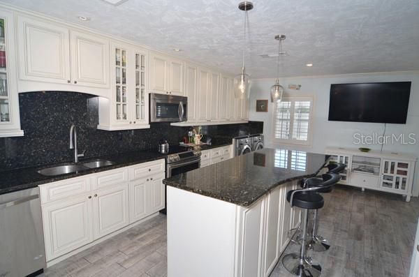 Gorgeous Kitchen with Granite backsplash and counters!! Tons of storage inside the island