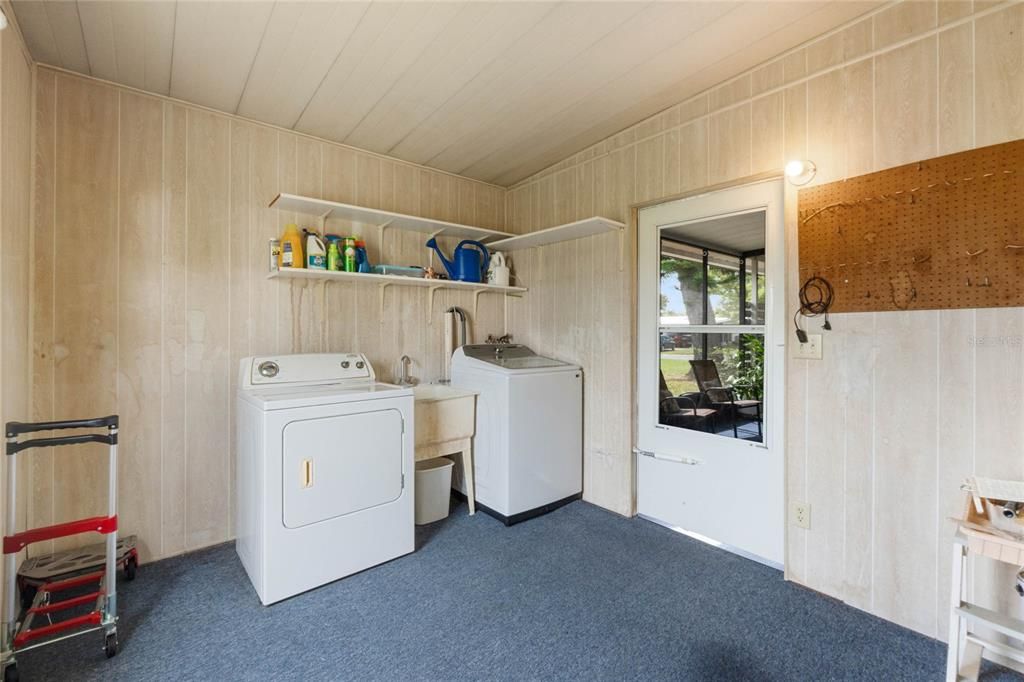 Separate laundry room and storage area