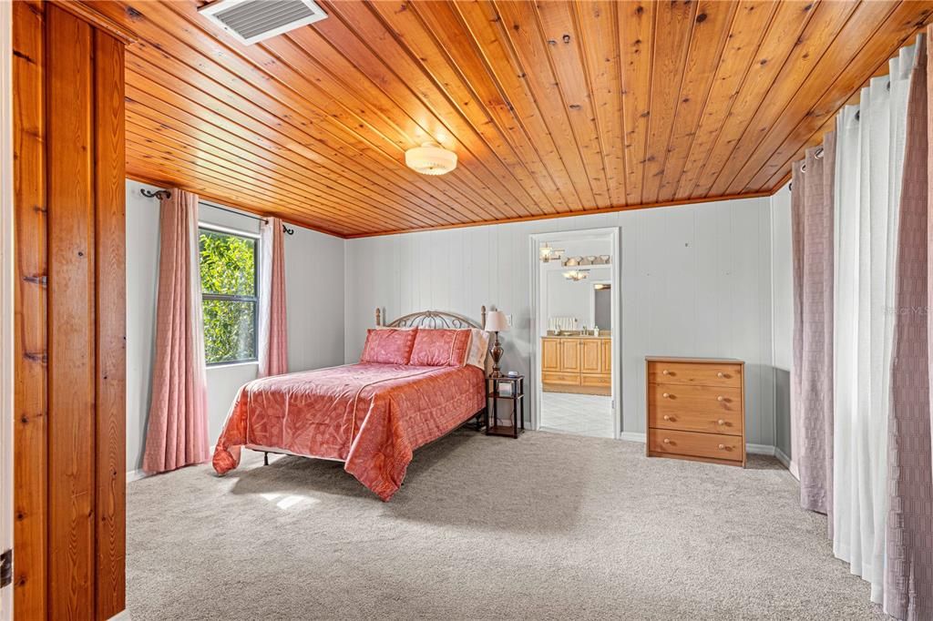 PRIMARY BEDROOM WITH PINE CEILINGS