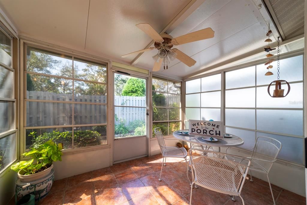 Tile floors and ceiling fan in enclosed porch