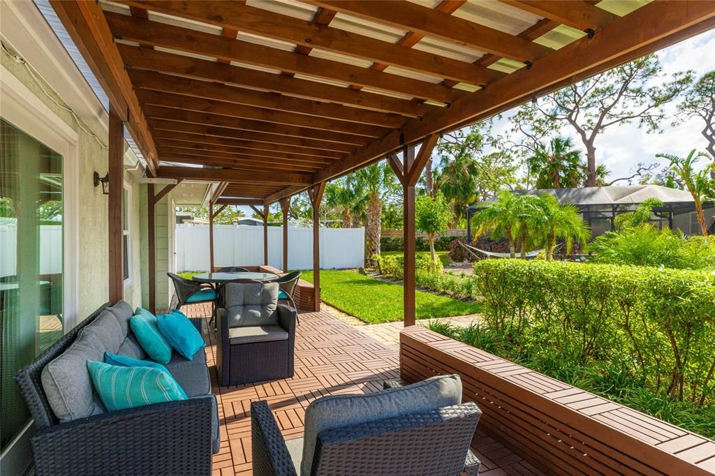 This inviting pergola creates a peaceful outdoor space, ideal for enjoying Sarasota’s beautiful weather year-round.