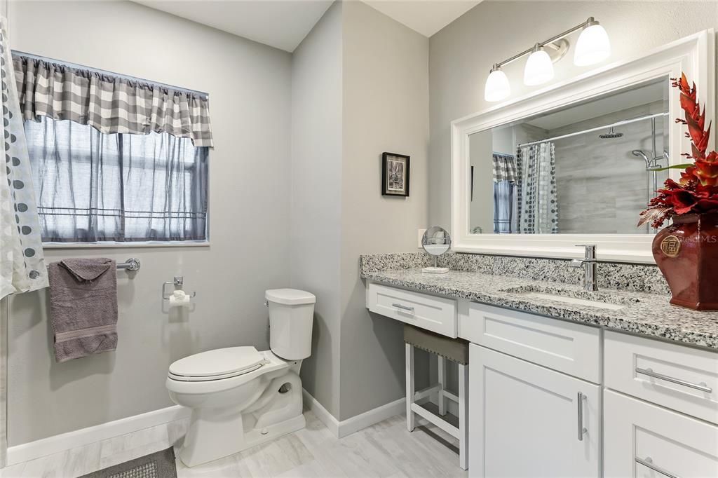 The spacious guest bathroom, thoughtfully designed with handicap accessibility.