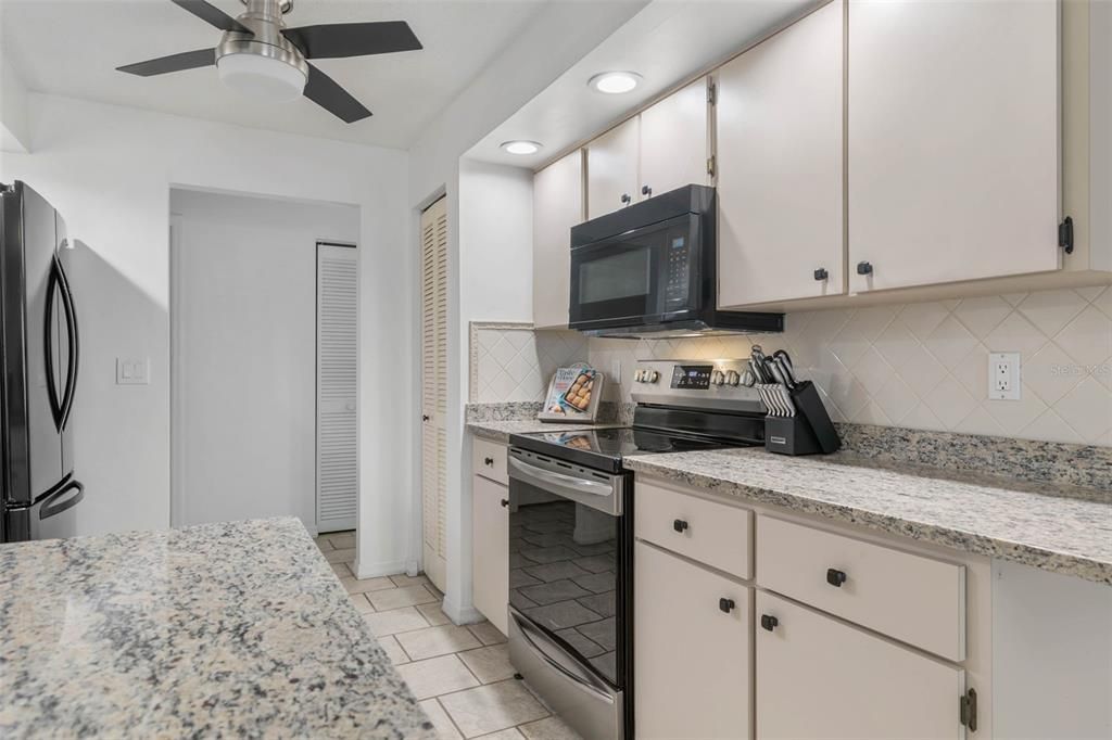 Kitchen with nice granite counters and recessed lighting