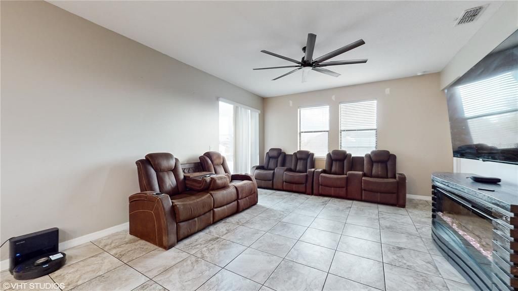 Great room with ceiling fan.