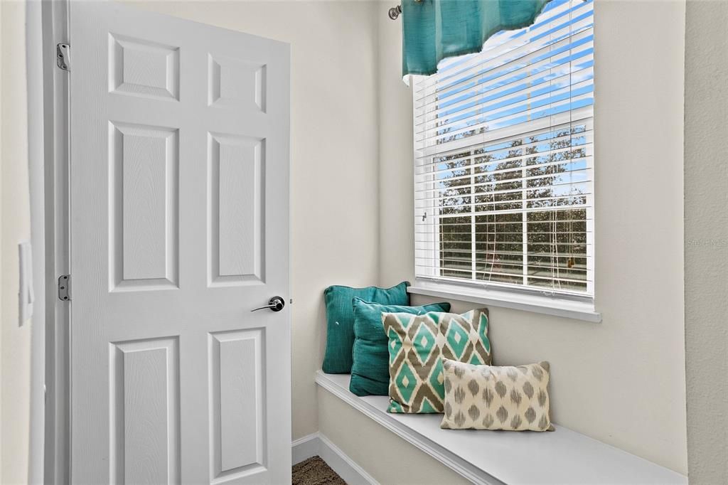 Bay window with seatee across from walk-in closet