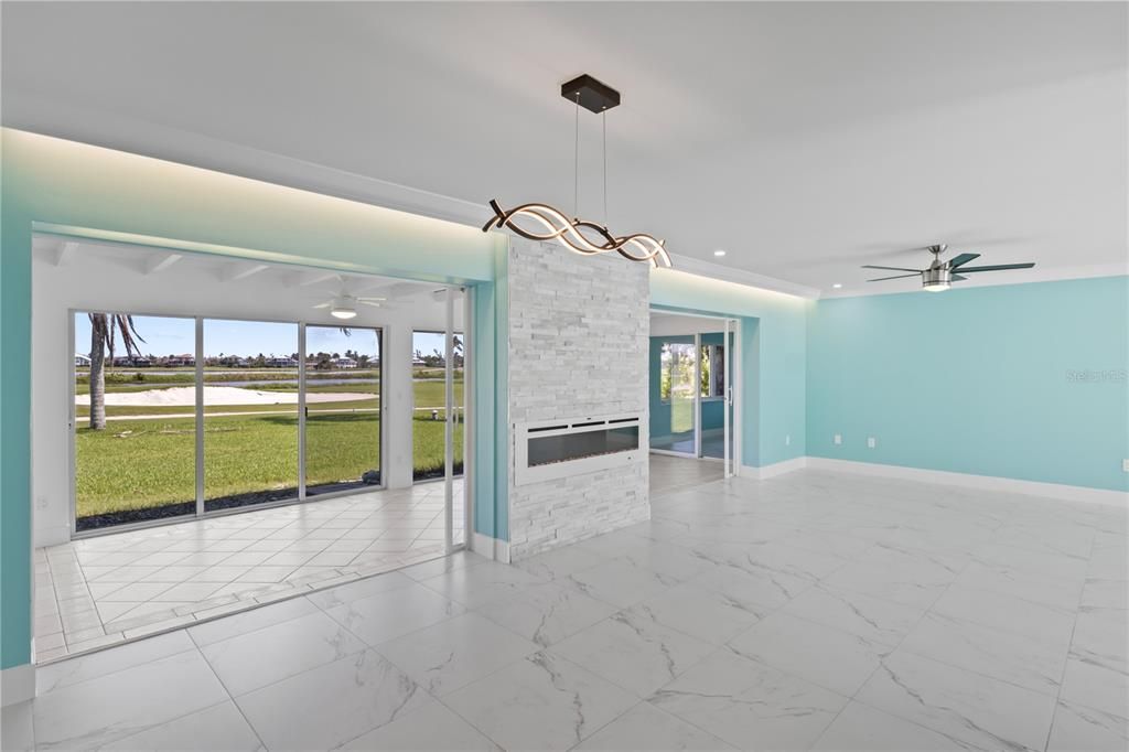 Unfurnished living room with ceiling fan and light tile patterned floors