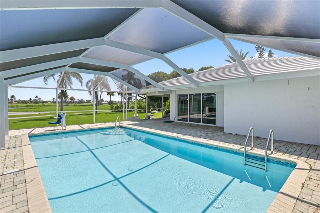 View of pool with a lanai, a patio area, and a yard