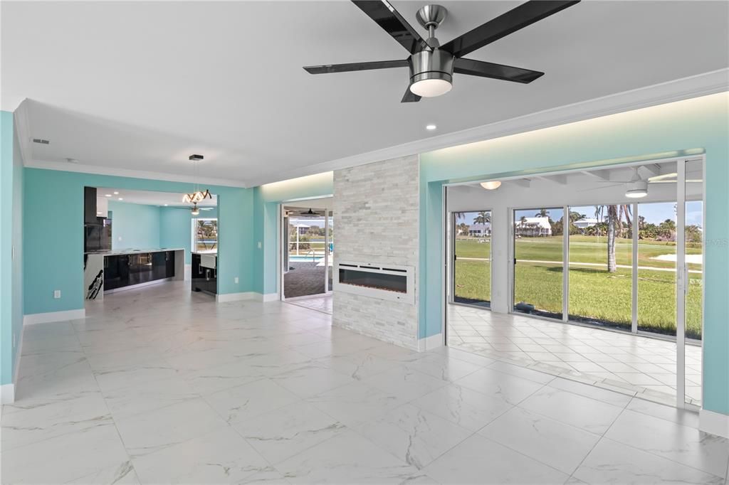 Living room is spacious and opens up to a secondary living space with wall of sliders and the most incredible views. Electric fireplace and ceiling wood trim add to the ambience of this amazing home!