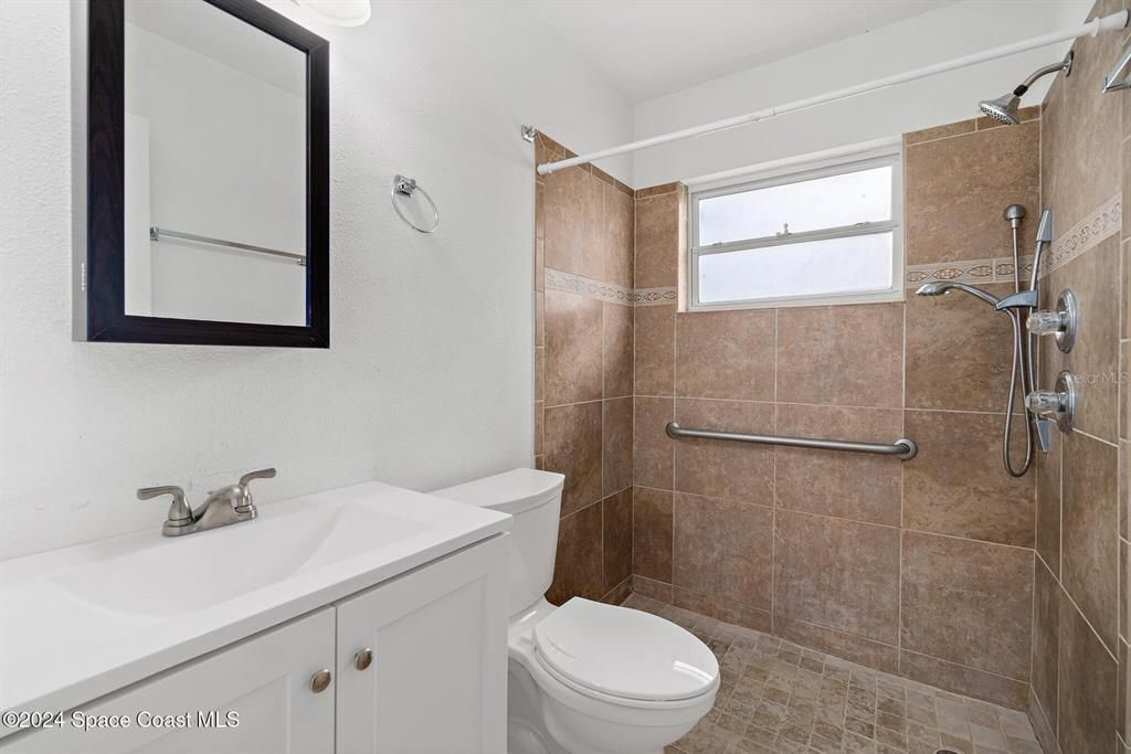 Updated guest bath with accessible tile shower