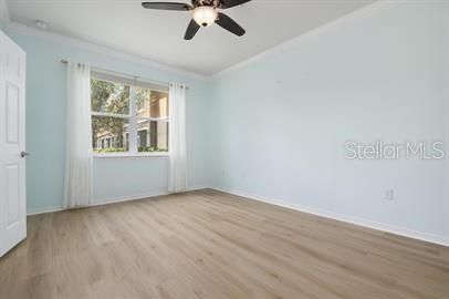 Master bedroom with elegant drapes and newly laid vinyl flooring