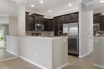 Stunning mocha cabinets add to the charming style of the kitchen