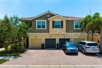 Tasteful front of townhome with upgraded tile roof