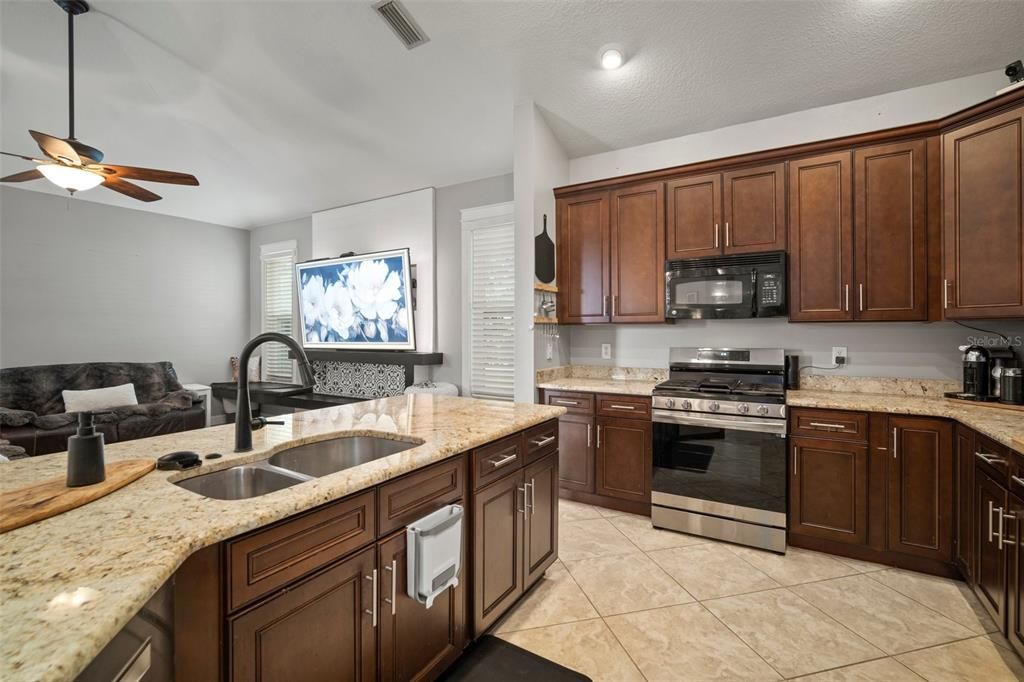 Kitchen- granite, wood cabinets, gas range