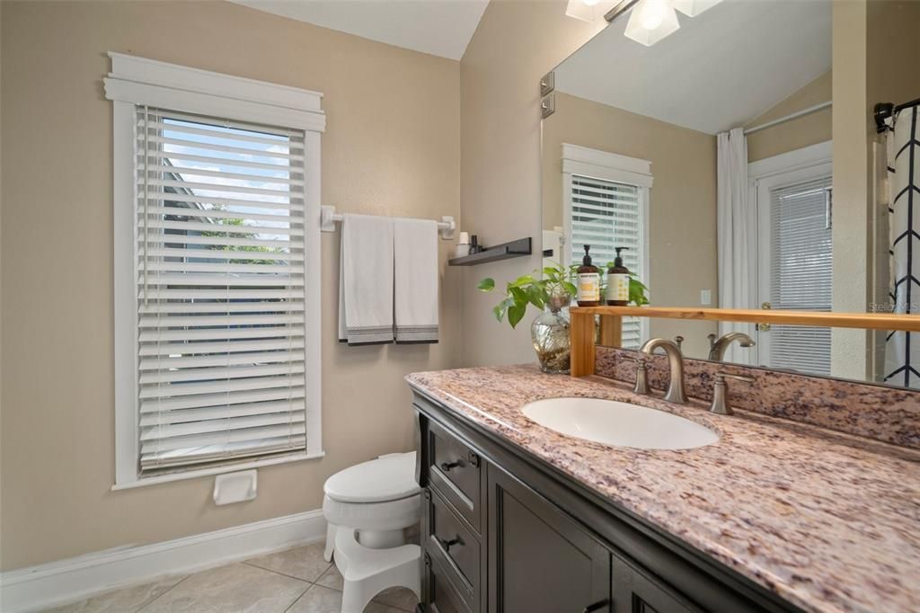 Secondary full bathroom with door access to lanai