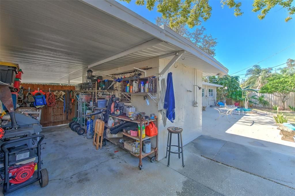 Attached work shed that is directly behind the carport