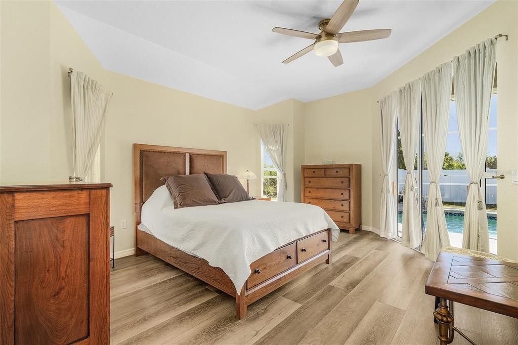 Primary bedroom with slider to lanai/pool