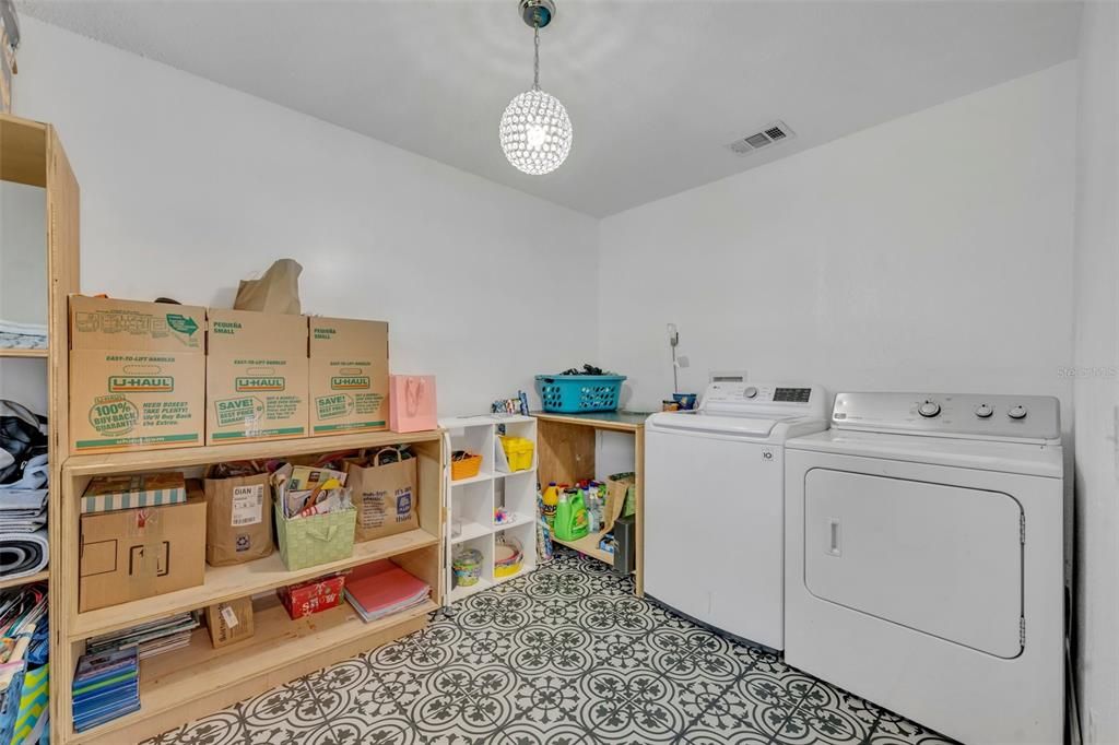 Inside laundry room with plenty of storage