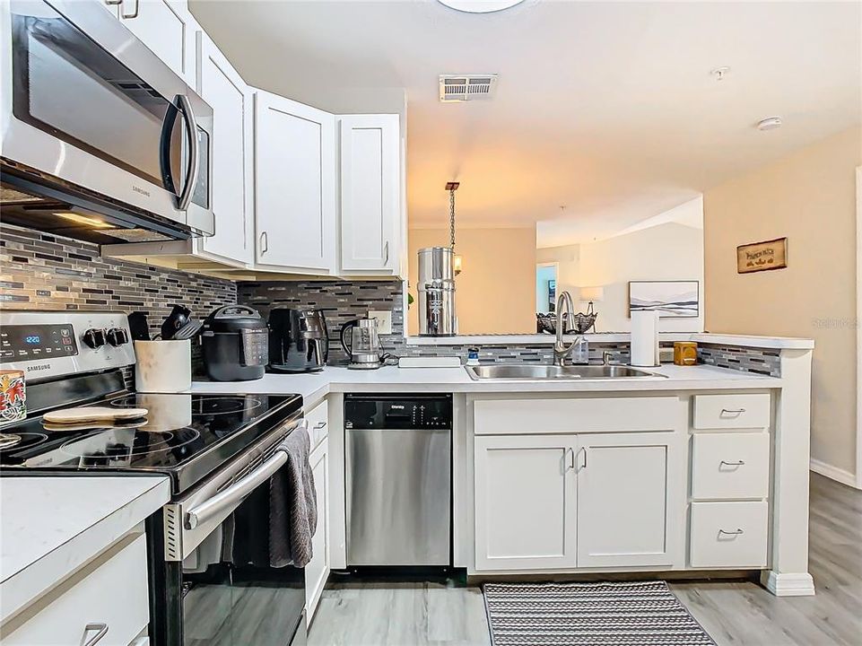 Fully renovated kitchen with updated soft-close cabinetry and polished countertops.