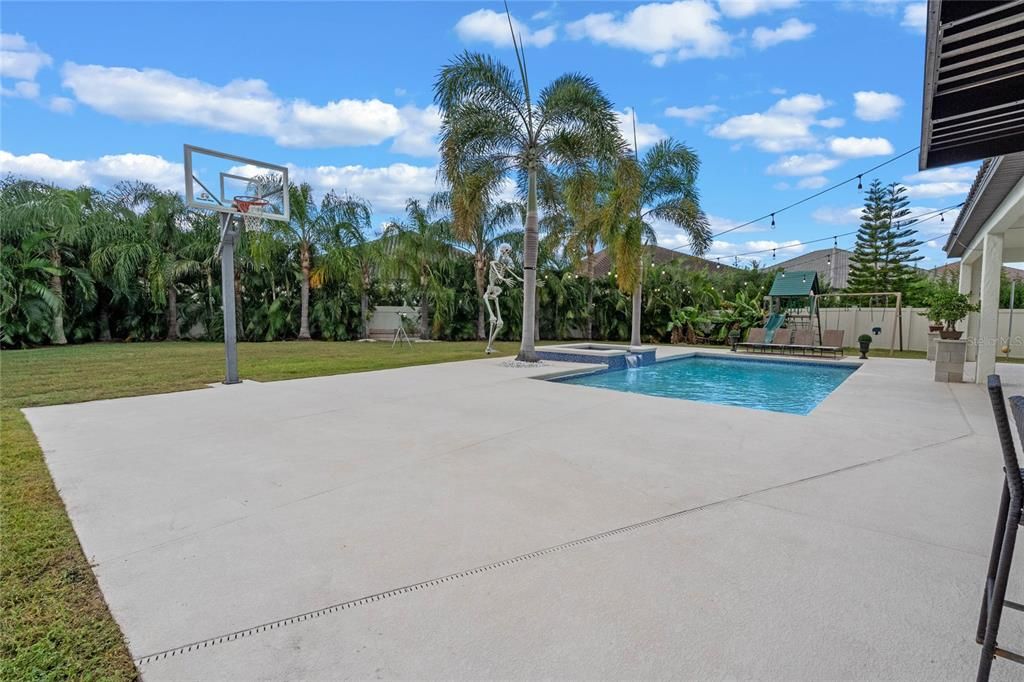 View of the half court basketball court area near the pool. This yard is HUGE !