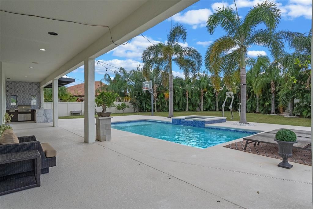 Plenty of covered patio space in this home ... plus a beautiful summer kitchen with Blaze grill, fridge, icemaker and sink with plenty of counter space.