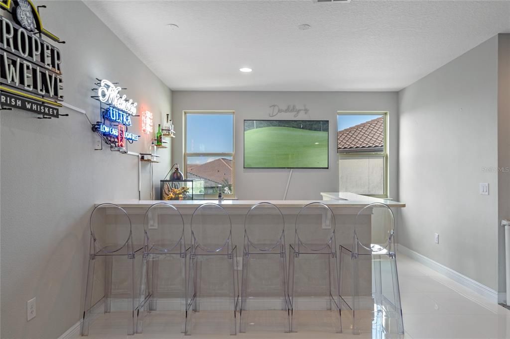 The second floor loft features a home bar area.